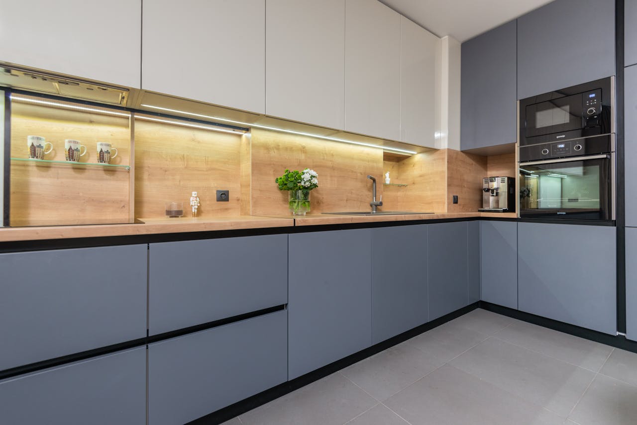 Sleek and contemporary kitchen interior design with modern built-in appliances and stylish cabinetry.